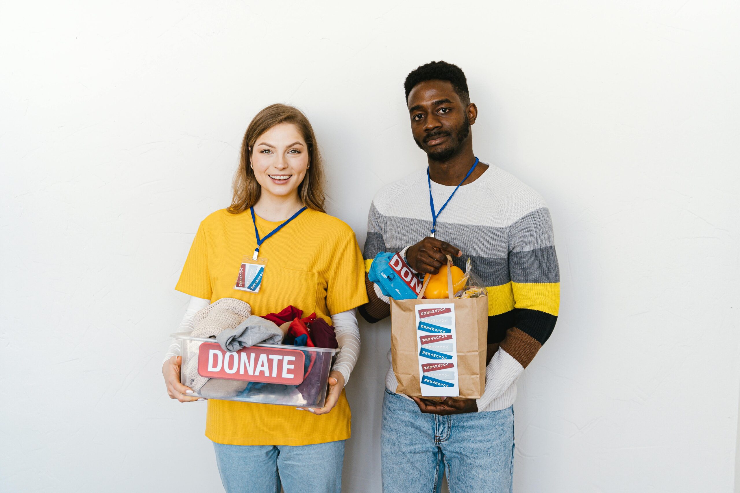 Volunteers holding donated items for a charitable donation drive