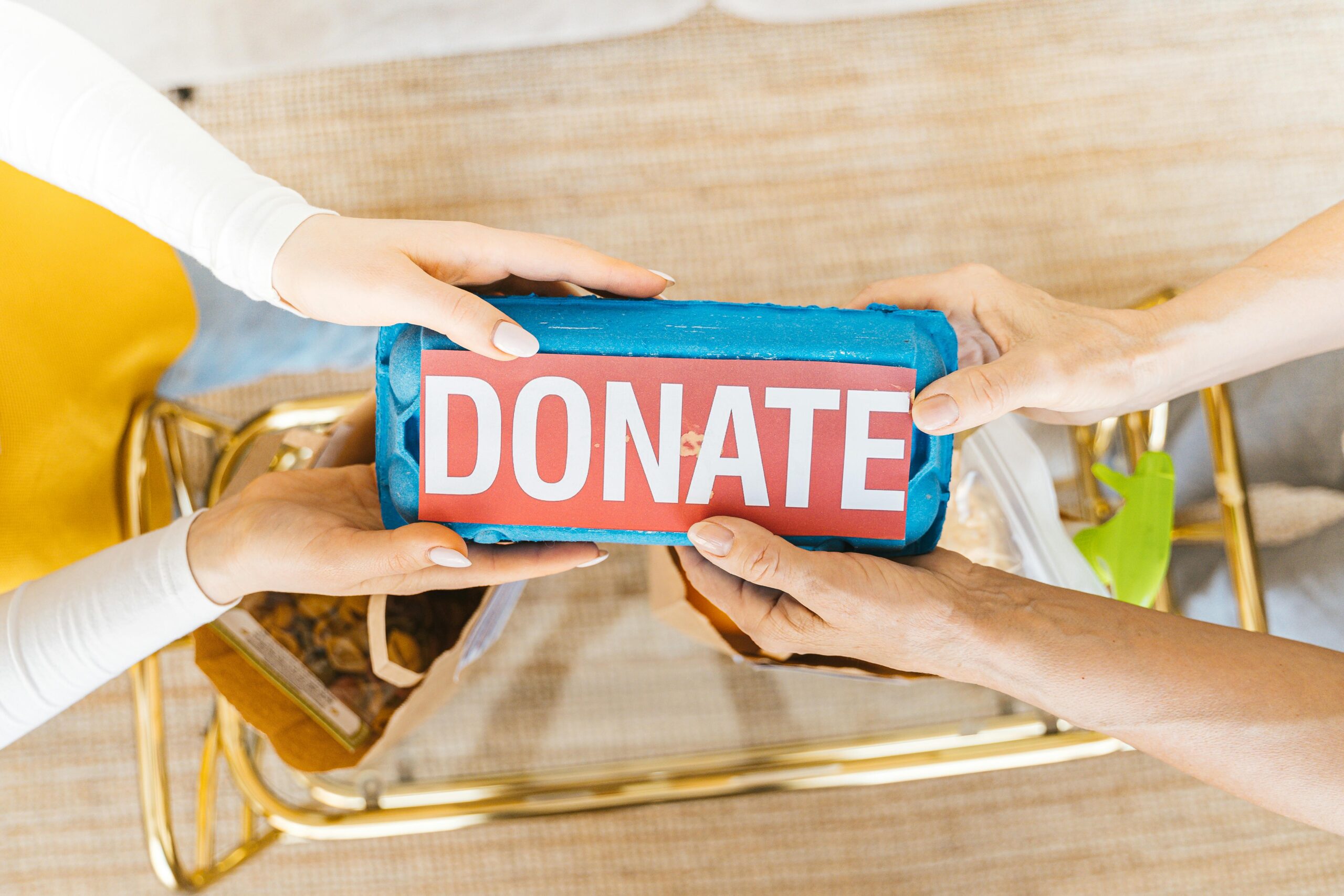 Hands exchanging a donation box for local donation pickup