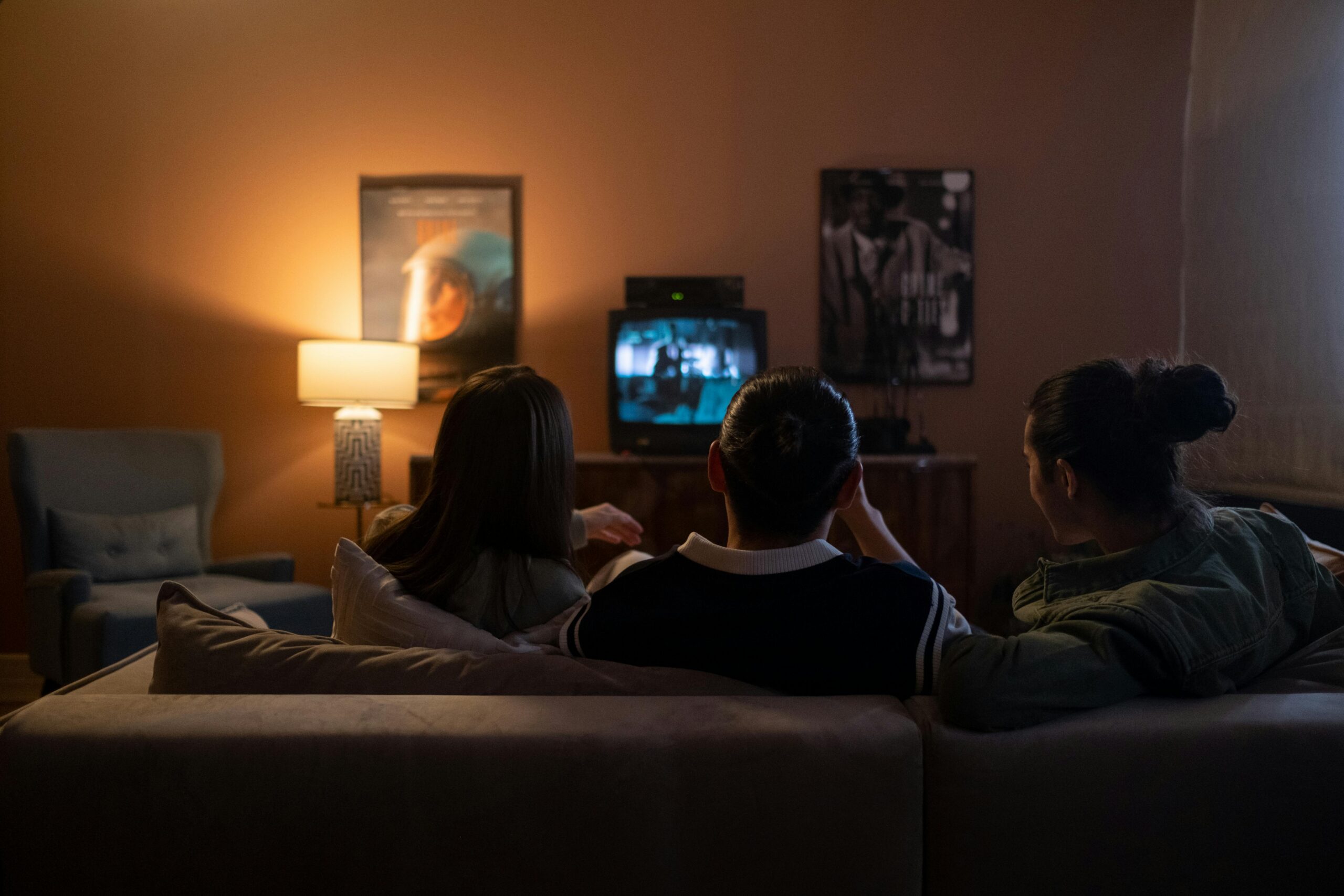 Family watching a flat screen TV at home